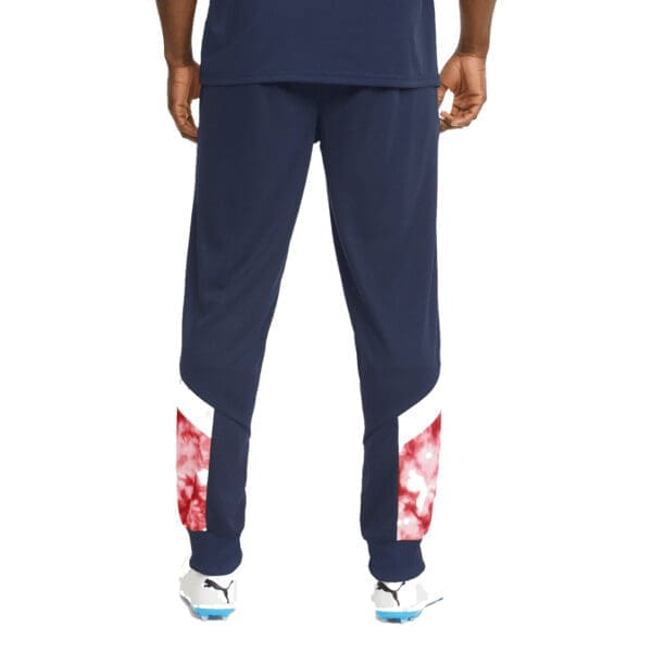 Man wearing blue sweatpants with red accents.