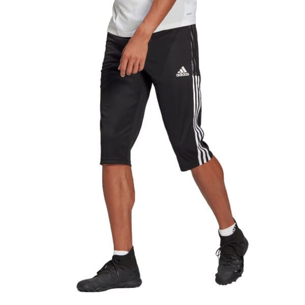 Man wearing black Adidas 3-stripe pants.