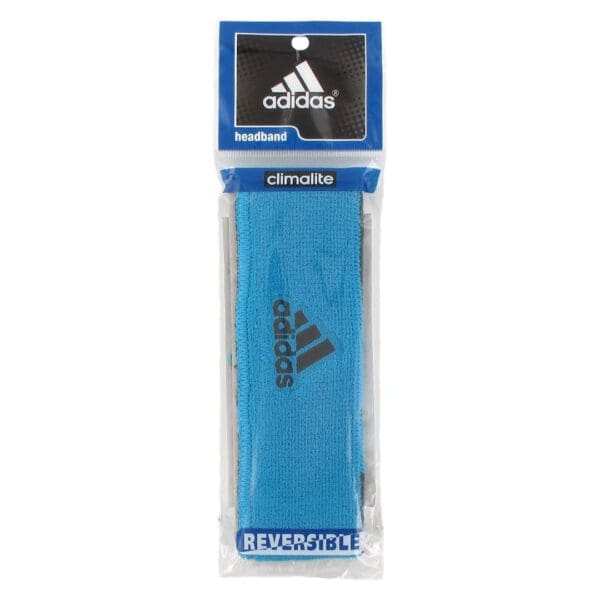 Blue Adidas reversible headband in packaging.