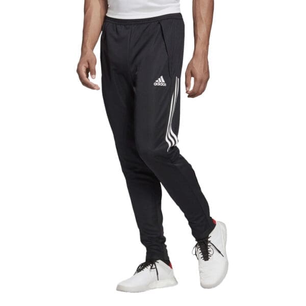 Man wearing black Adidas track pants.