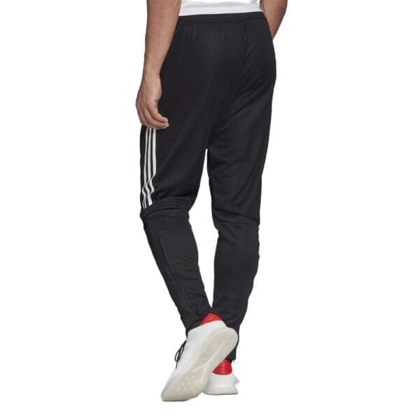 Black Adidas track pants with white stripes.