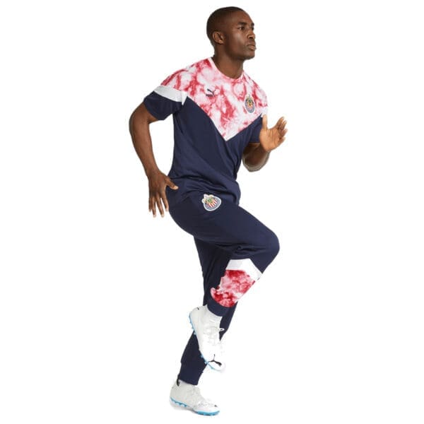 Man in blue Puma soccer uniform running.