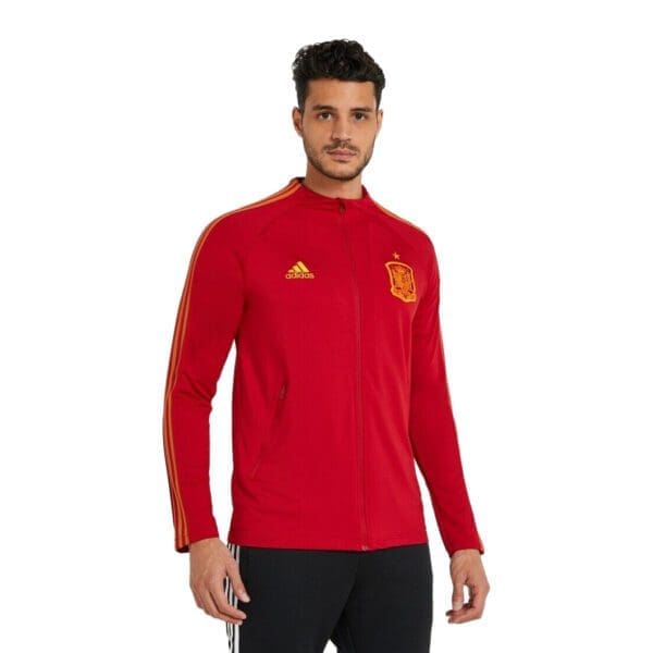 Man wearing red Adidas Spain jacket.