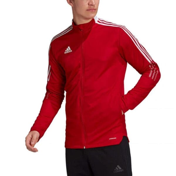 Red Adidas track jacket with white stripes.