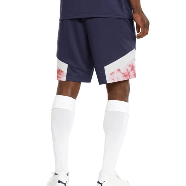 Man wearing navy blue shorts with tie dye detail.