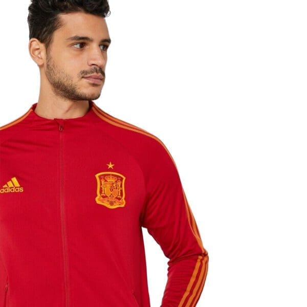 Man wearing a red Spain soccer jacket.