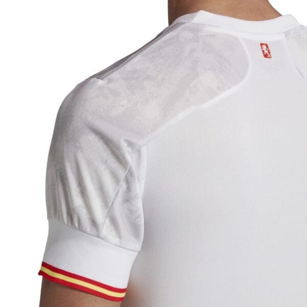 White soccer jersey with red trim.