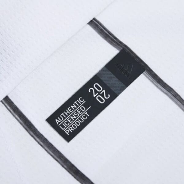 White shirt with black stripes and label.