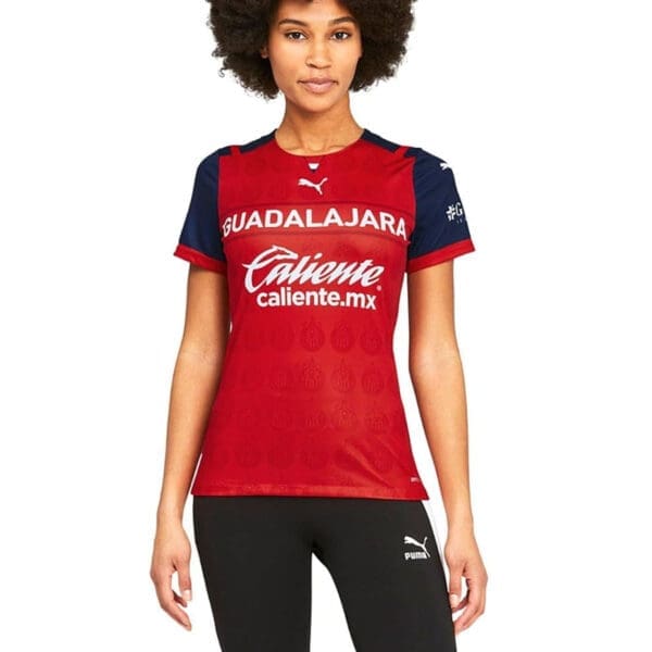 Woman wearing red Guadalajara soccer jersey.