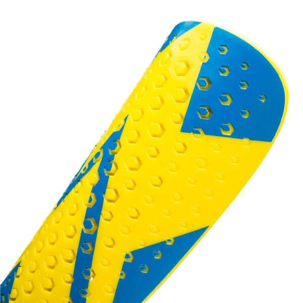 Yellow and blue shin guard with padding.