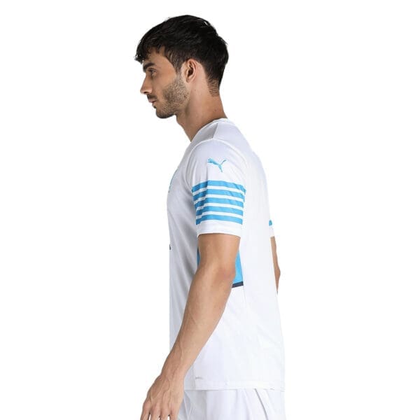 Man wearing a white Puma soccer jersey.