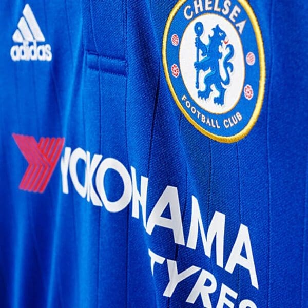 Chelsea FC blue football jersey with sponsor logo.