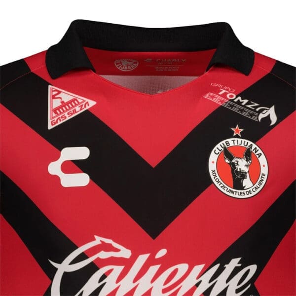 Red and black soccer jersey with logo.