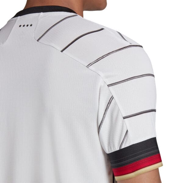 White soccer jersey with black stripes.