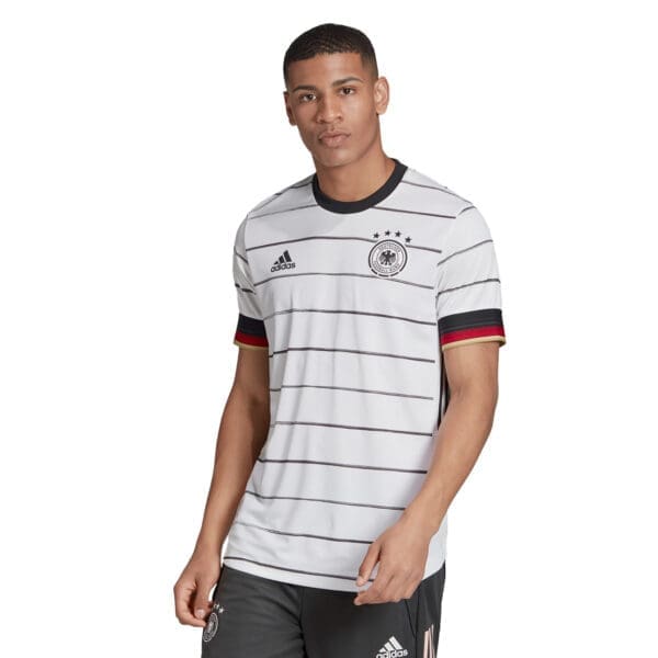 Man wearing Germany soccer jersey by Adidas.