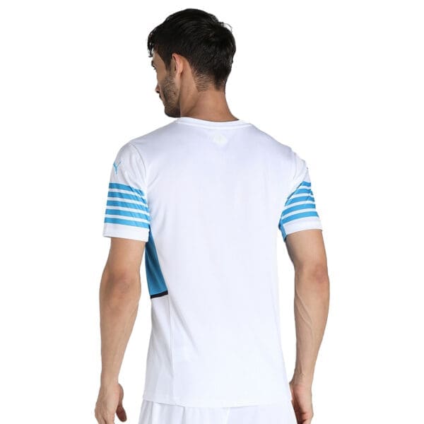 White t-shirt with blue stripes on sleeve.