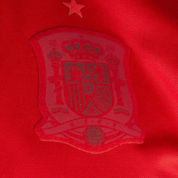 Spain national team crest on red jersey.