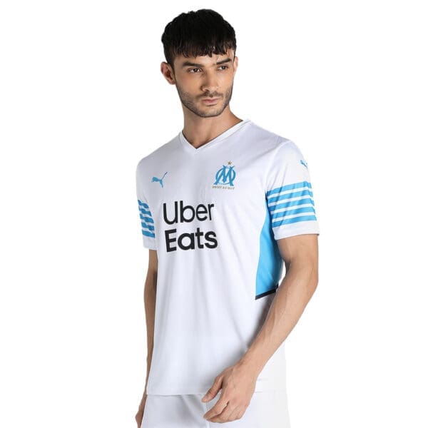 Man wearing a white Marseille soccer jersey.