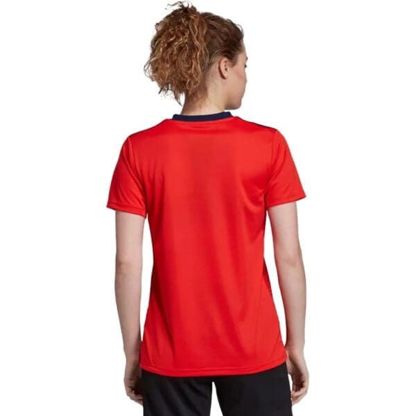 Woman in red Adidas soccer jersey