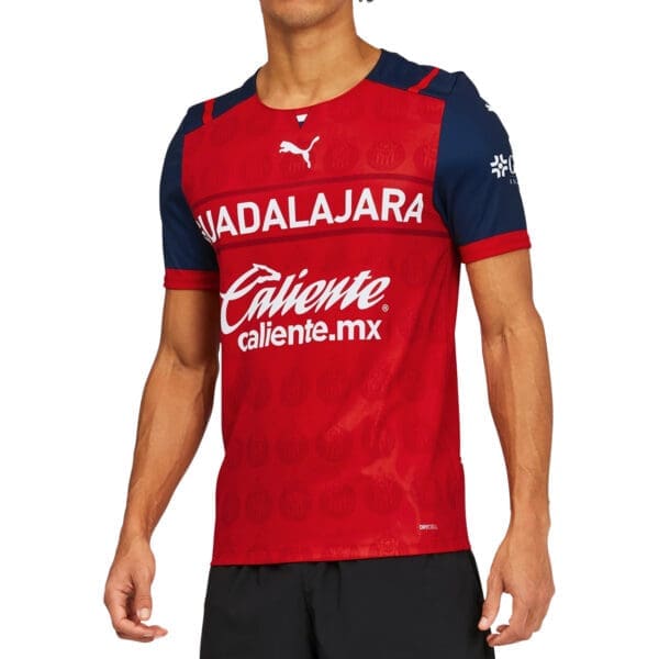 Man wearing a red Guadalajara soccer jersey.