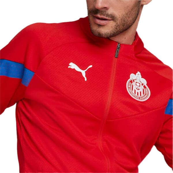 Red Puma jacket with team logo.