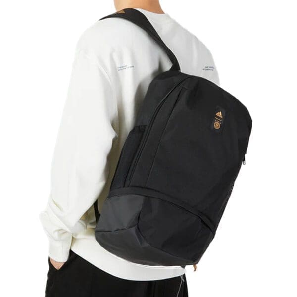 Black Adidas backpack with gold logo.