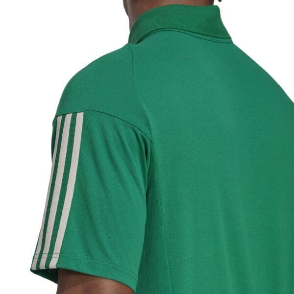 Green adidas polo shirt with white stripes.