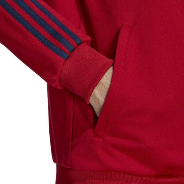 Red adidas track jacket with blue stripes.