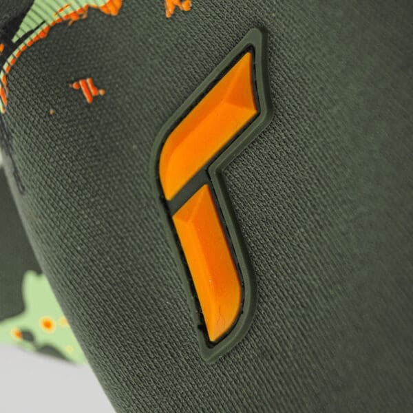 Orange letter F on green fabric.