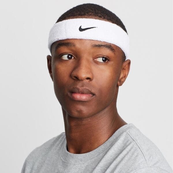 Man wearing white Nike headband.