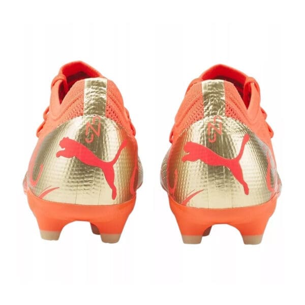 Orange and gold Puma soccer cleats.