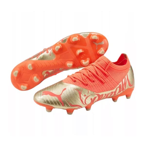 Orange and gold Puma soccer cleats.