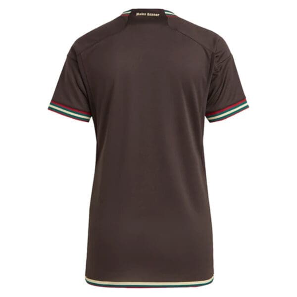 Brown soccer jersey with green and gold trim.