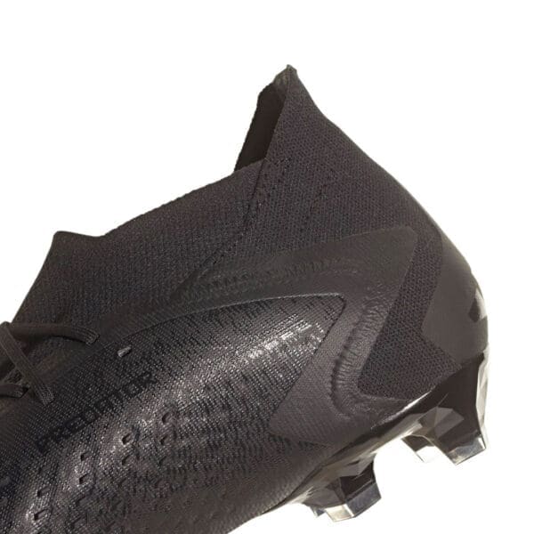 Black Adidas soccer cleats with studs.