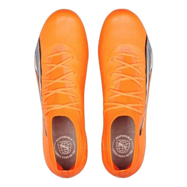 Orange soccer cleats with laces.