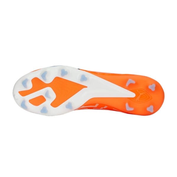 Orange and white soccer cleat bottom view.