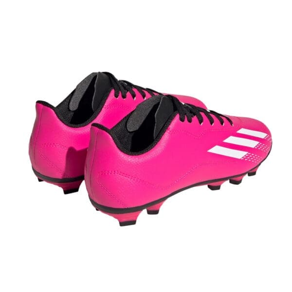 Pink Adidas soccer cleats with white stripes.