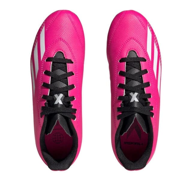 Pink Adidas soccer cleats with white stripes.