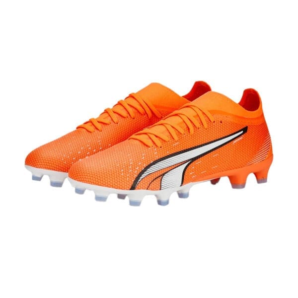 Orange and white Puma soccer cleats.