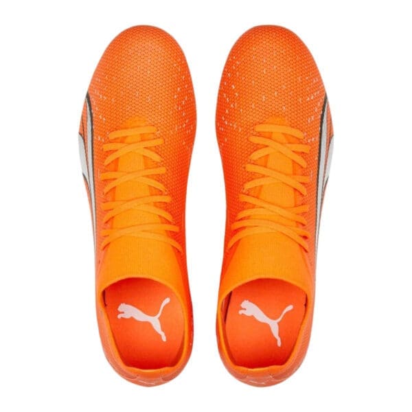 Orange and white Puma soccer cleats.