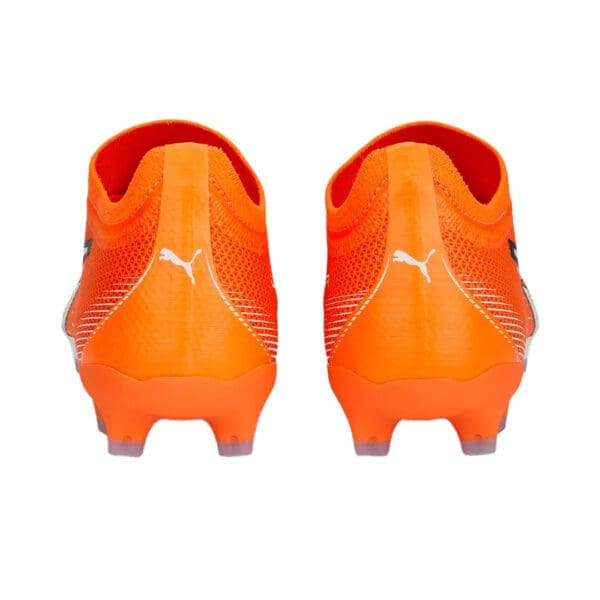 Orange Puma football boots with studs.