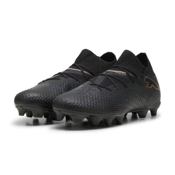 Black Puma soccer cleats with gold accents.