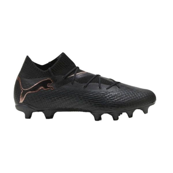 Black and rose gold Puma soccer cleats.