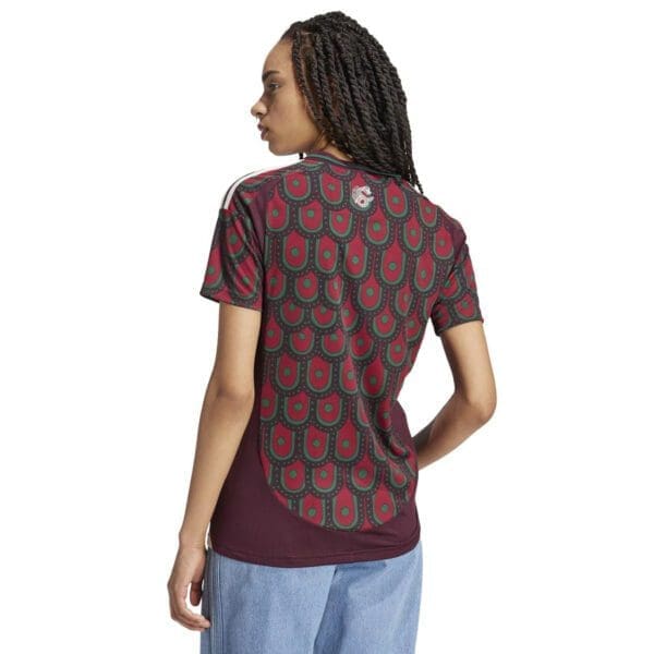 Woman wearing a red patterned t-shirt.