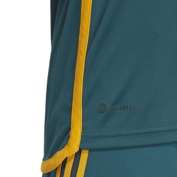 Teal athletic shirt with yellow trim