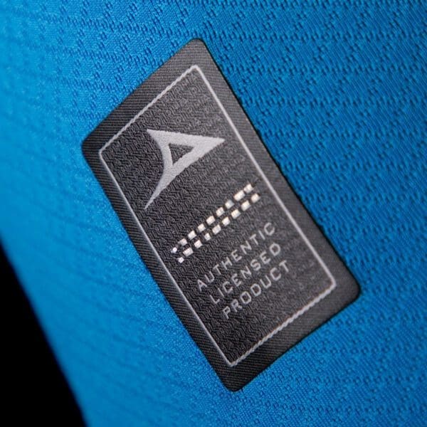 Authentic licensed product tag on blue fabric.