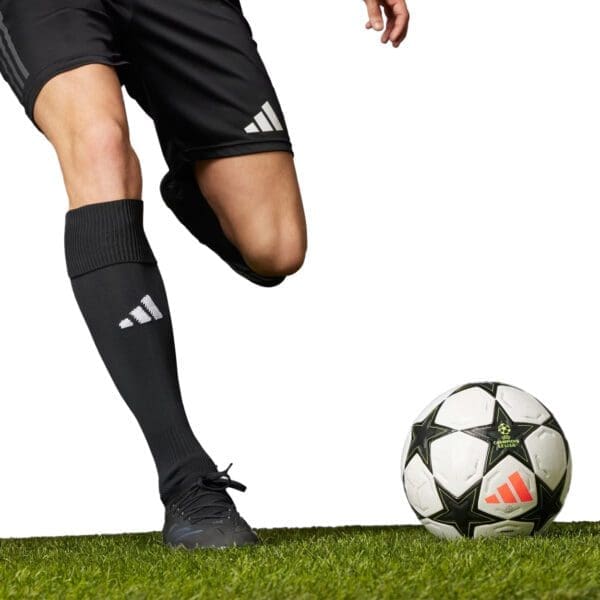 Soccer player with black adidas socks and cleats.