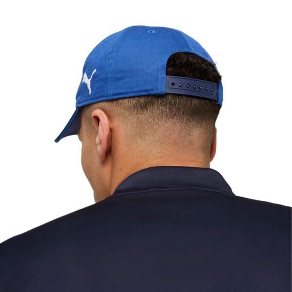 Man wearing a blue Puma baseball cap.