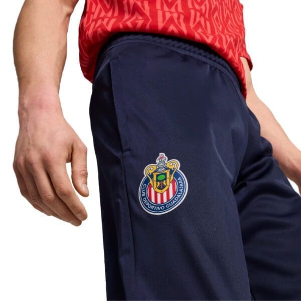 Blue soccer pants with team logo.