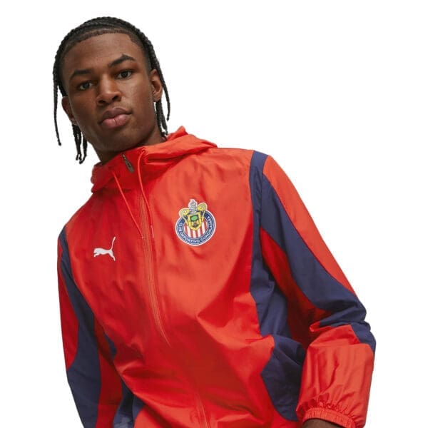 Man wearing red and blue Puma jacket.